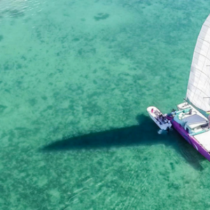 Enjoy breakfast at a beach resort and cruise on crystal clear blue waters aboard a catamaran