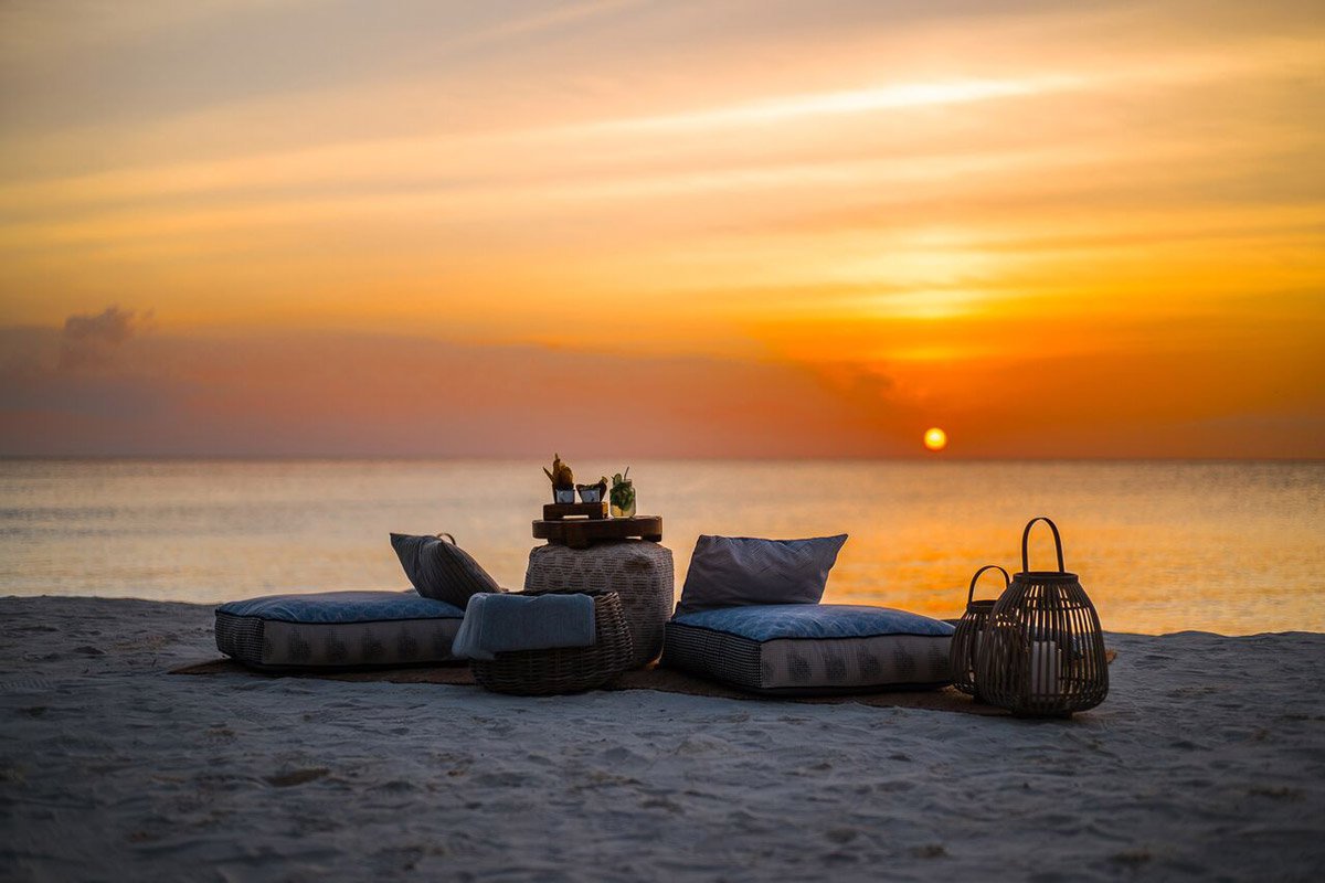 Enjoy a breath-taking sunset while enjoying a cocktail on the beach with your partner when on this unforgettable trip