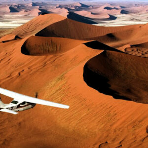 Explore Dead Vlei, a dazzling white clay pan dotted with ancient fossilised camel thorn trees